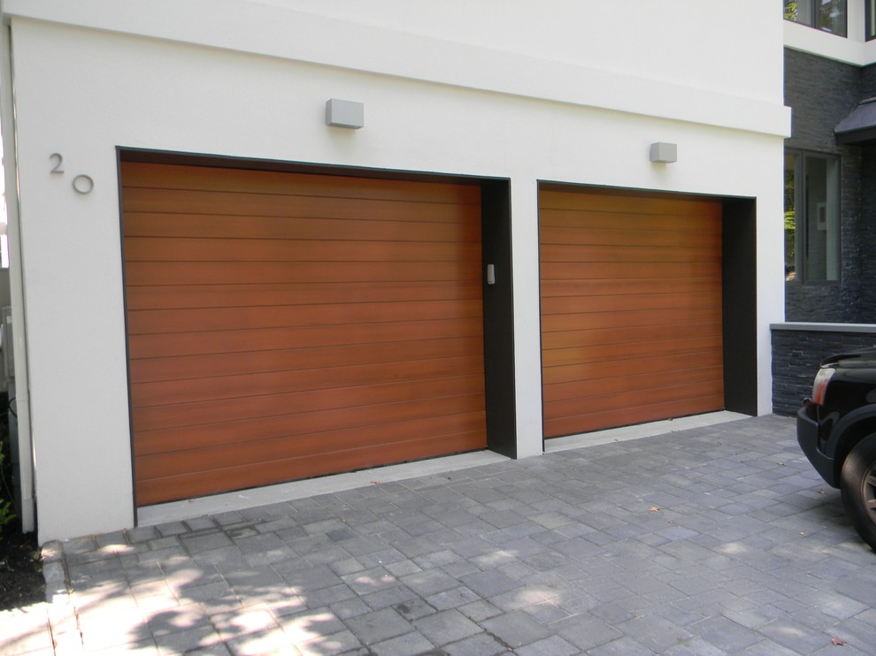 Minimalist attached two-car garage photo in New York