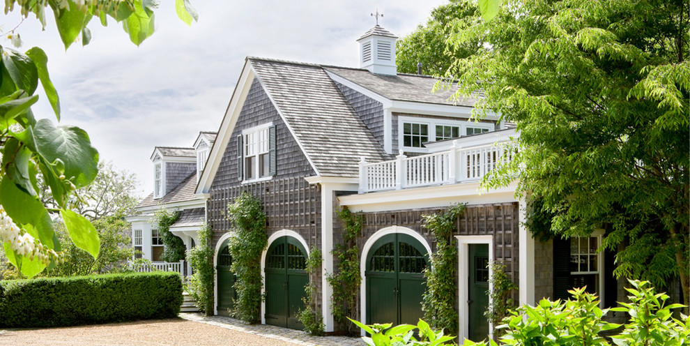 Example of a large classic detached three-car garage design in Boston