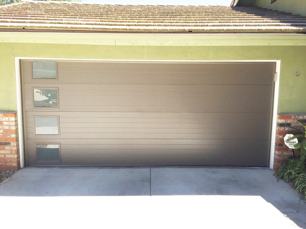 Garage - transitional attached two-car garage idea in San Diego