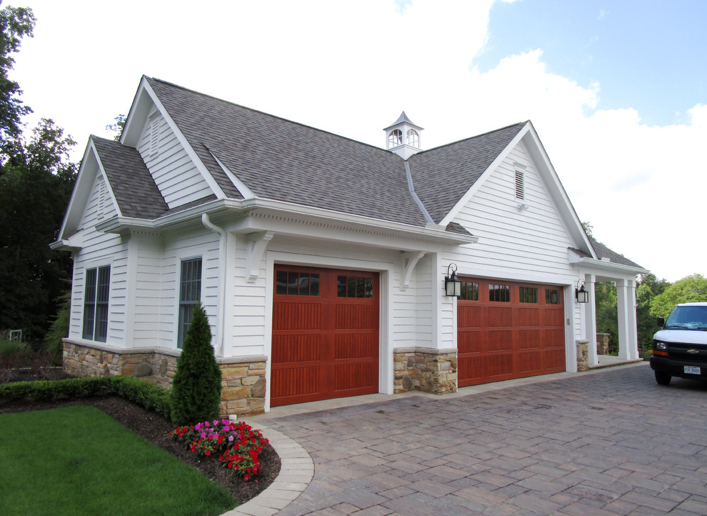 Mid-sized transitional detached three-car garage photo in Cleveland
