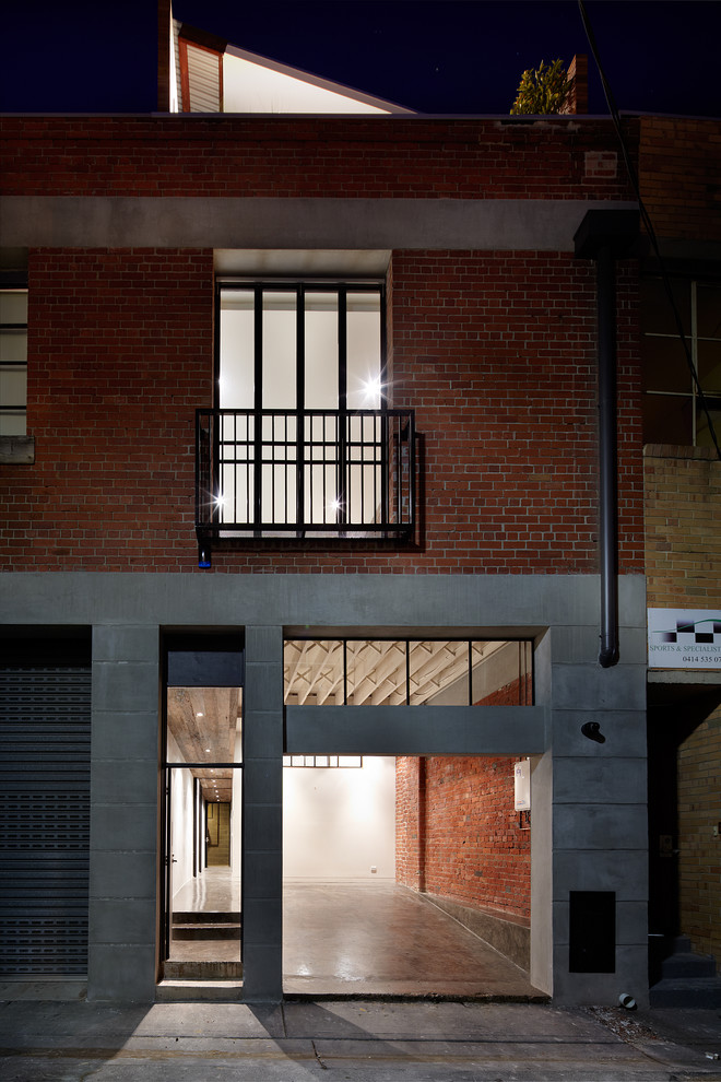 Example of an urban attached garage design in Melbourne