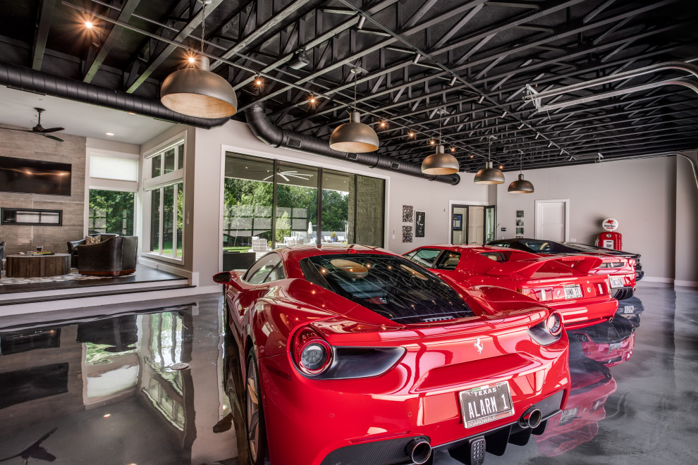 This is an example of an expansive traditional attached garage in Dallas with four or more cars.