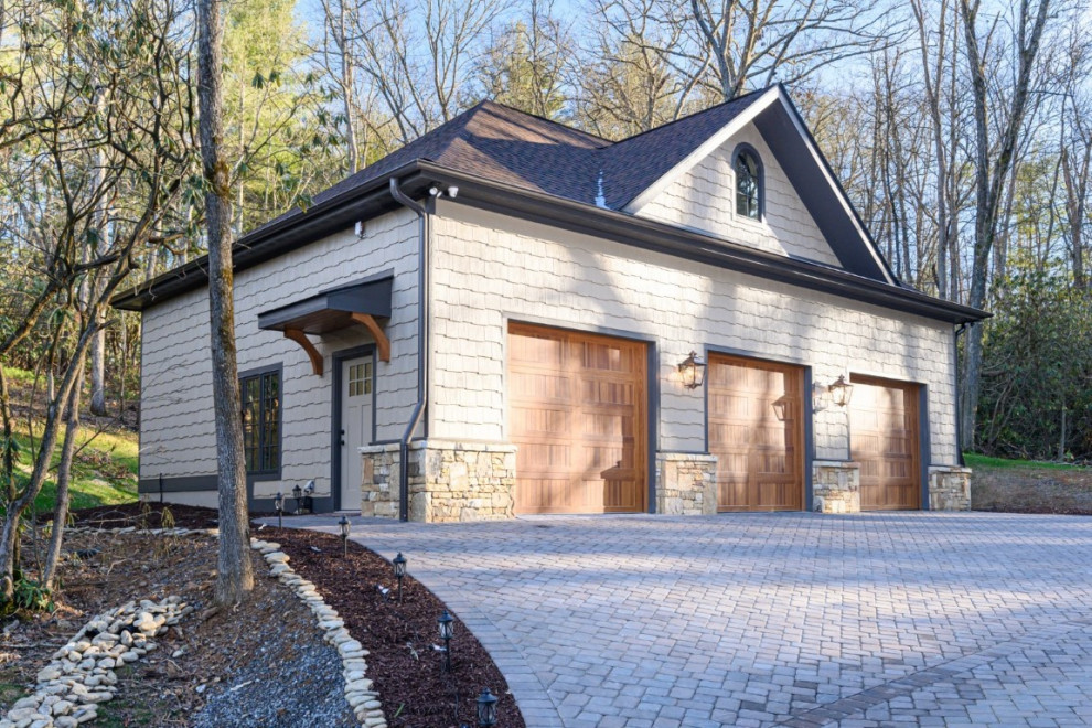 Inspiration for a large transitional detached three-car garage remodel in Other