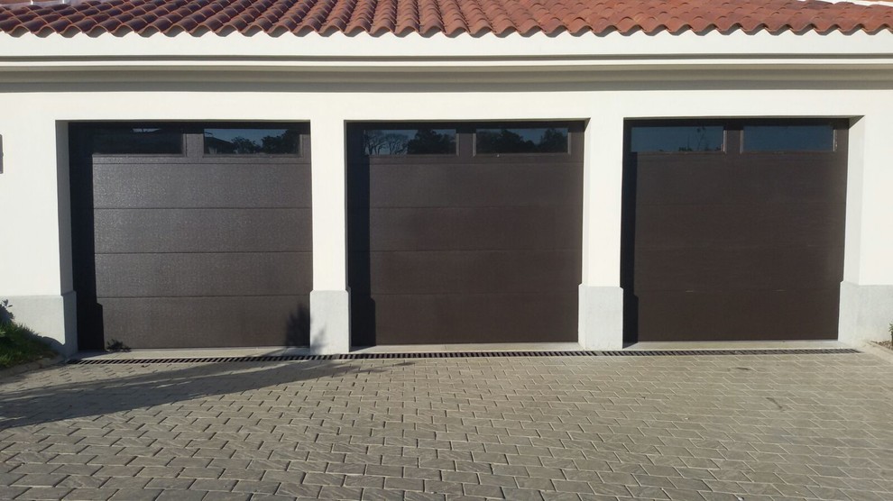 Example of a large minimalist detached two-car garage design in Other