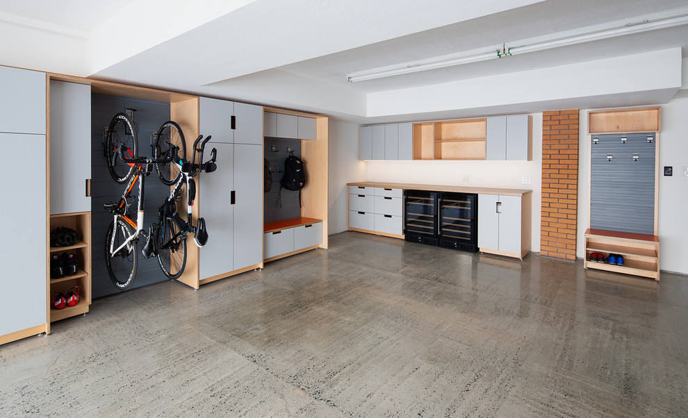 Réalisation d'un grand garage pour deux voitures attenant minimaliste avec un bureau, studio ou atelier.