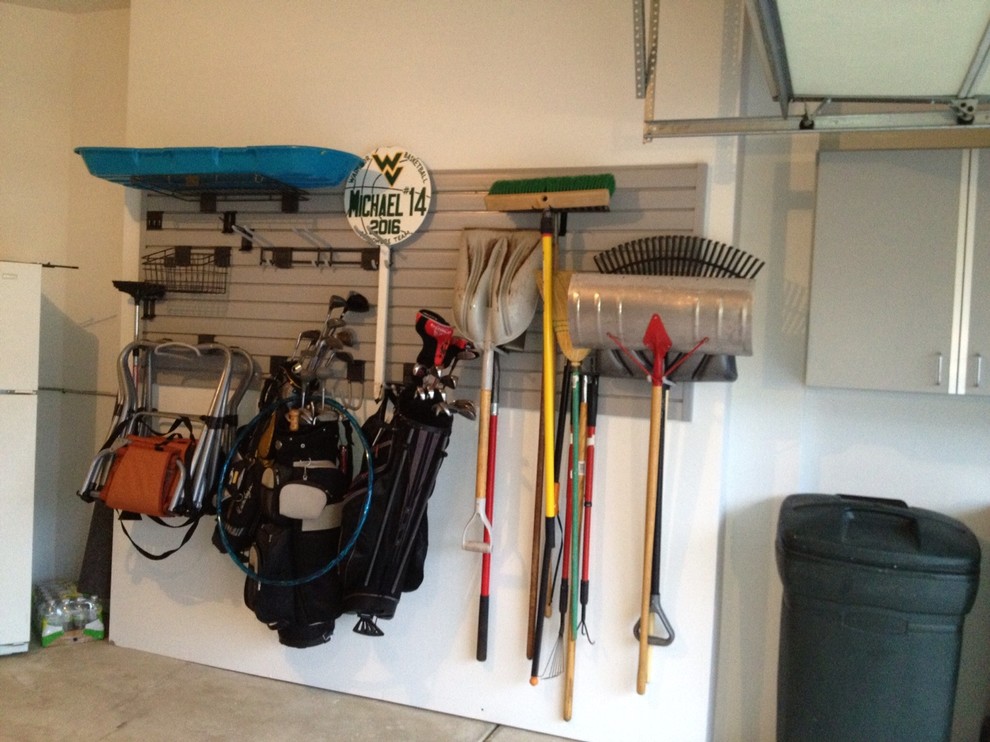 Garage - small industrial attached two-car garage idea in Chicago