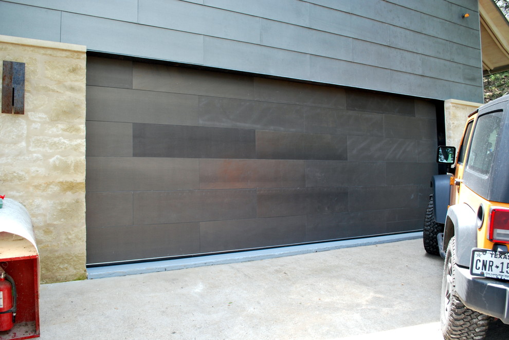 This is an example of a large modern attached double garage in Austin.
