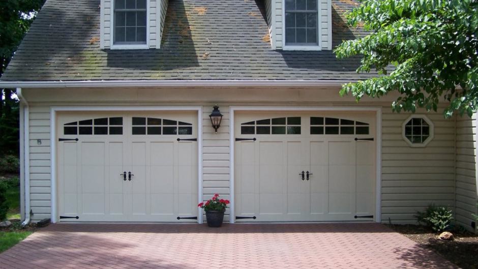 Garage - large traditional attached two-car garage idea in Dallas