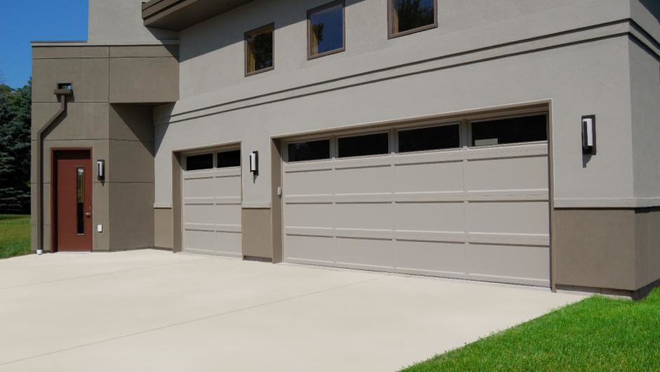 This is an example of a large contemporary attached garage in Dallas with three or more cars.