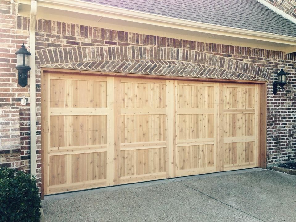 Garage - large traditional attached two-car garage idea in Dallas