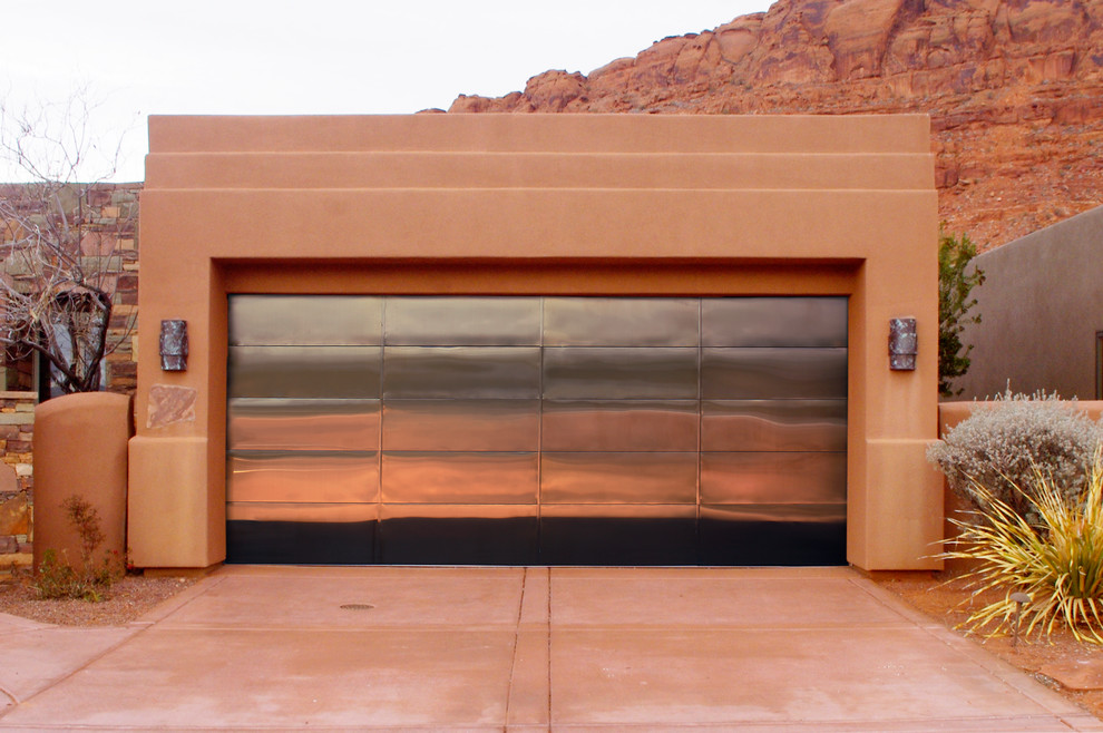 Inspiration for a large modern attached two-car garage remodel in Las Vegas