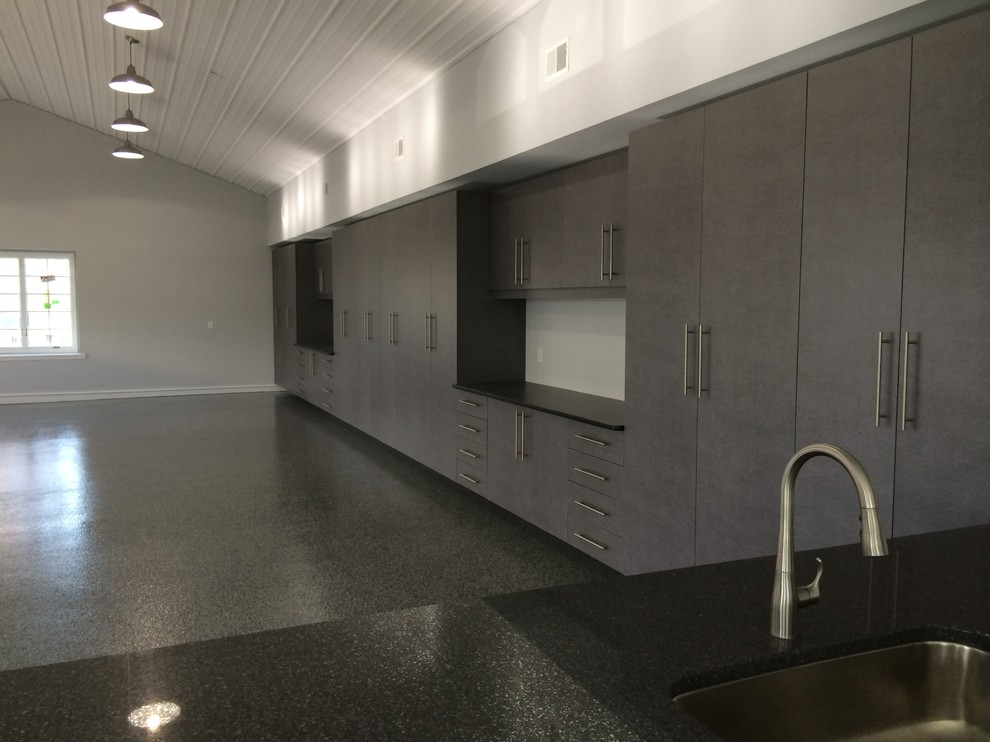 Design ideas for an expansive modern attached garage workshop in Detroit.