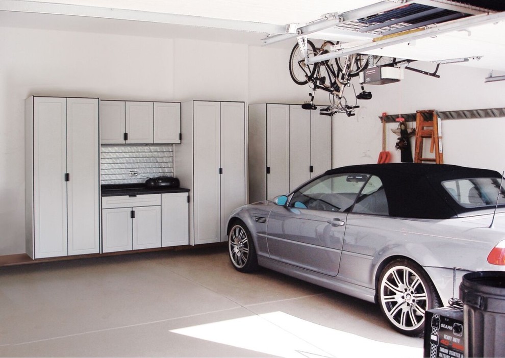 Large transitional two-car garage workshop photo in Kansas City