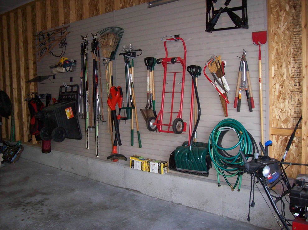 Garage - large traditional attached two-car garage idea in Other
