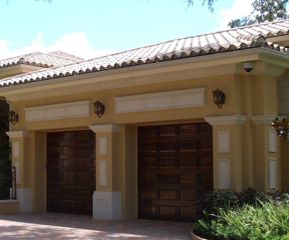 This is an example of an expansive mediterranean attached double carport in Miami.