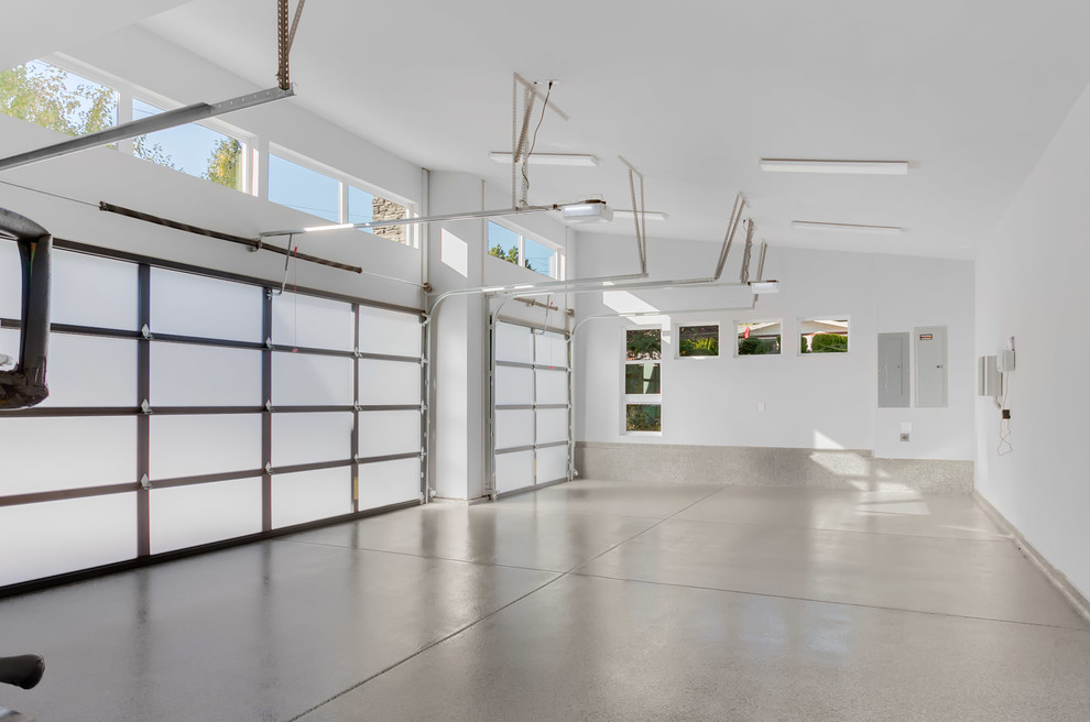This is an example of a large contemporary attached garage in Seattle with three or more cars.