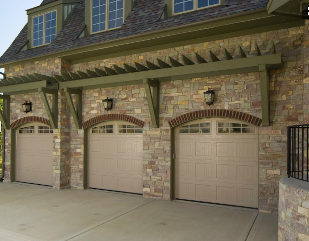 Inspiration for a large timeless attached three-car garage remodel in New York