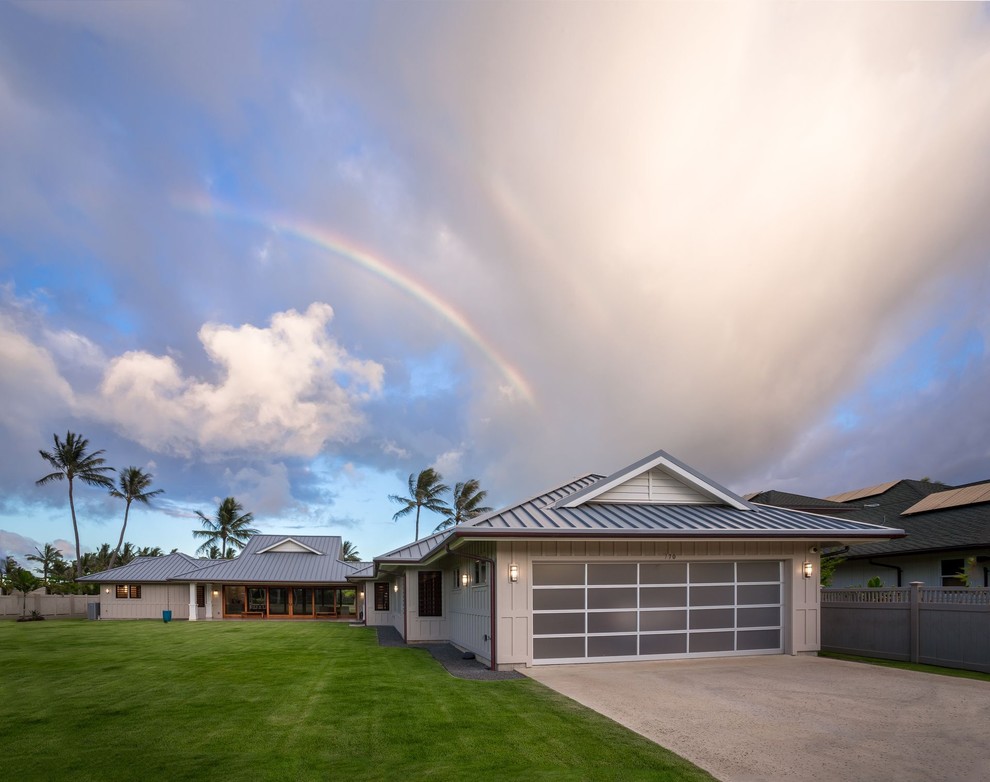 Inspiration for a large tropical attached two-car garage remodel in Hawaii