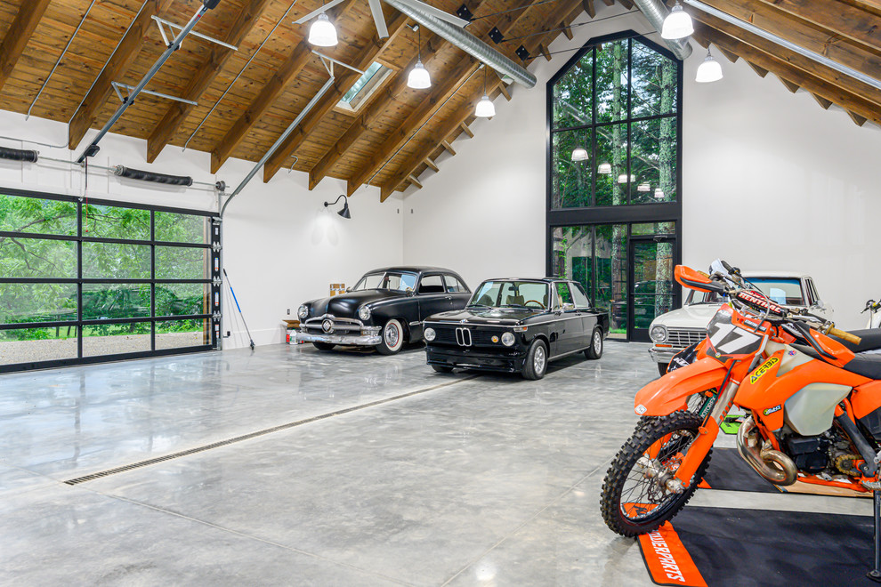 Photo of an expansive urban detached garage workshop in Other with four or more cars.