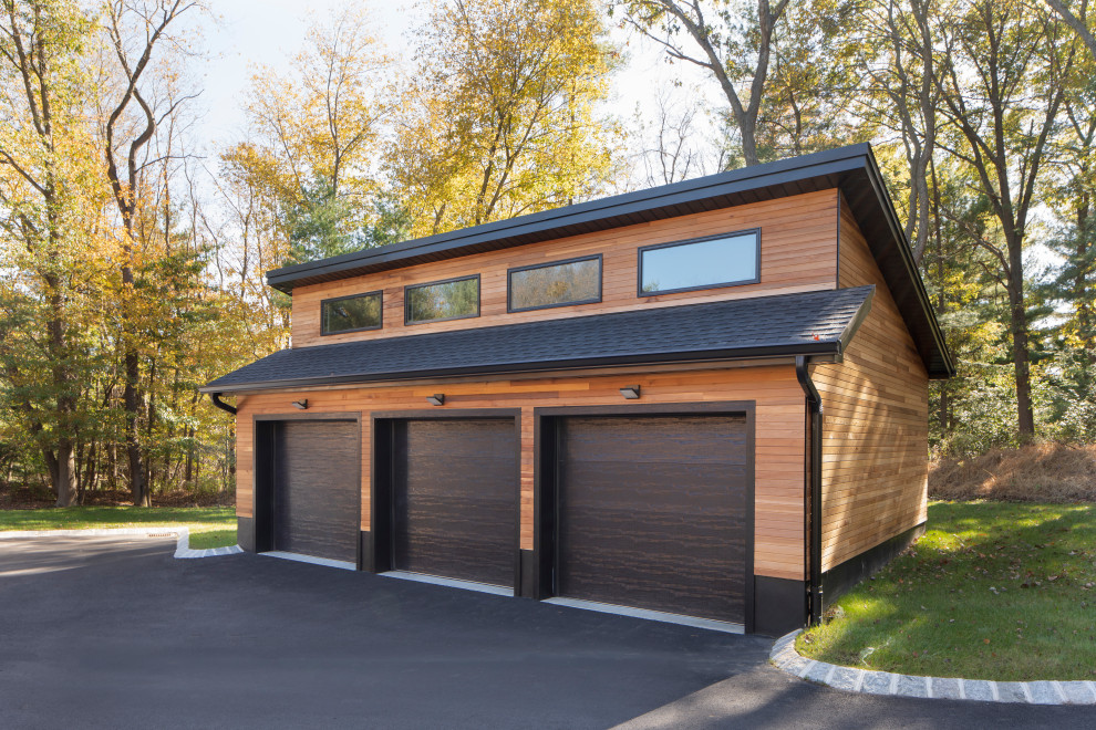 Garage - contemporary detached three-car garage idea in New York