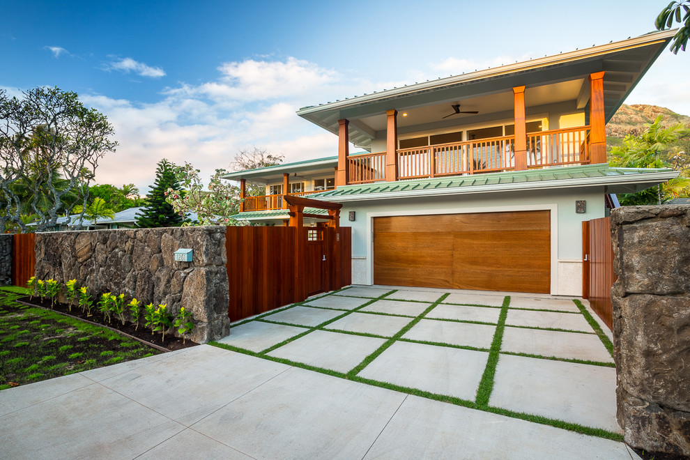Large island style attached two-car garage photo in Hawaii