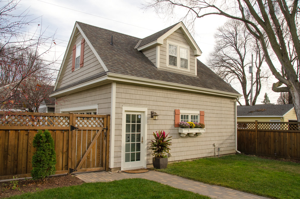 This is an example of a small traditional detached double garage in Minneapolis.