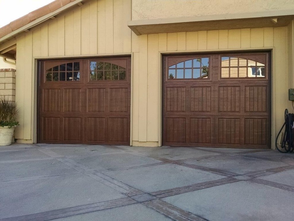 Inspiration for a large mediterranean attached two-car garage remodel in Orange County