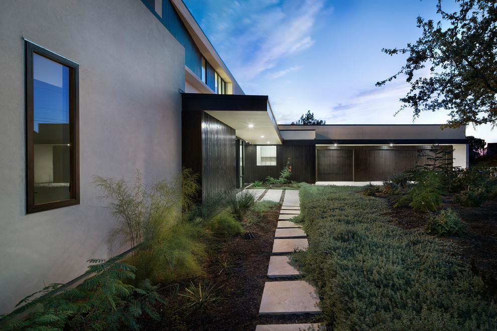 Inspiration for a huge contemporary attached three-car garage remodel in Austin