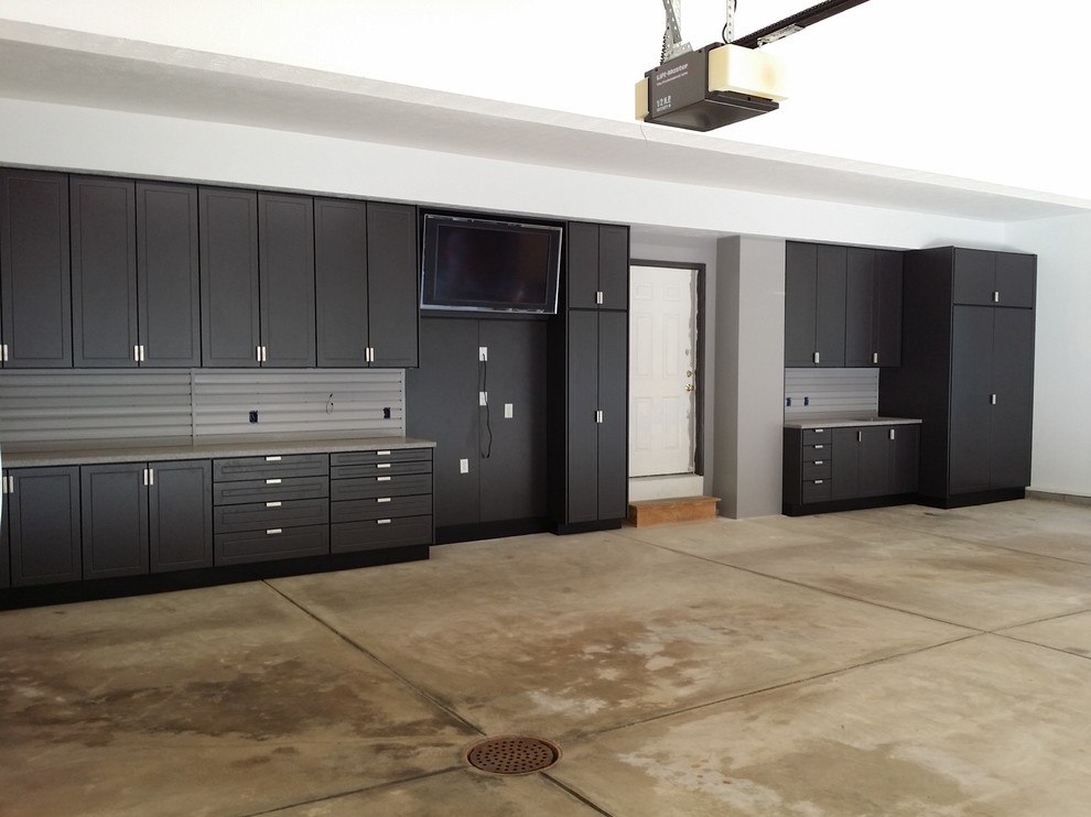 This is an example of a large industrial attached garage workshop in Cleveland with three or more cars.