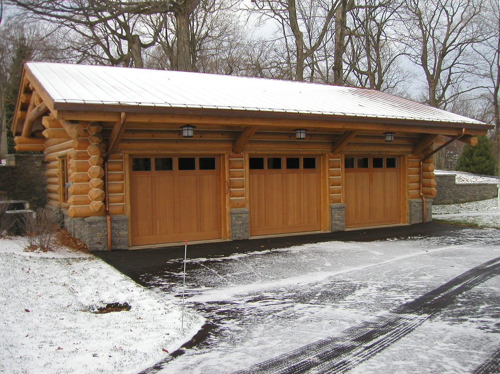 Example of a large mountain style detached three-car garage design in Minneapolis