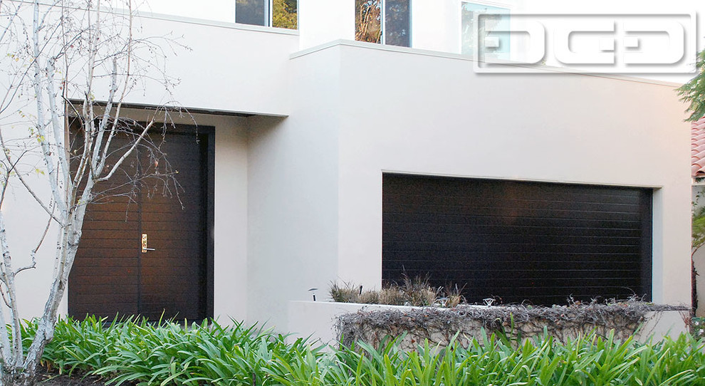 Example of a mid-sized minimalist attached two-car garage design in Los Angeles