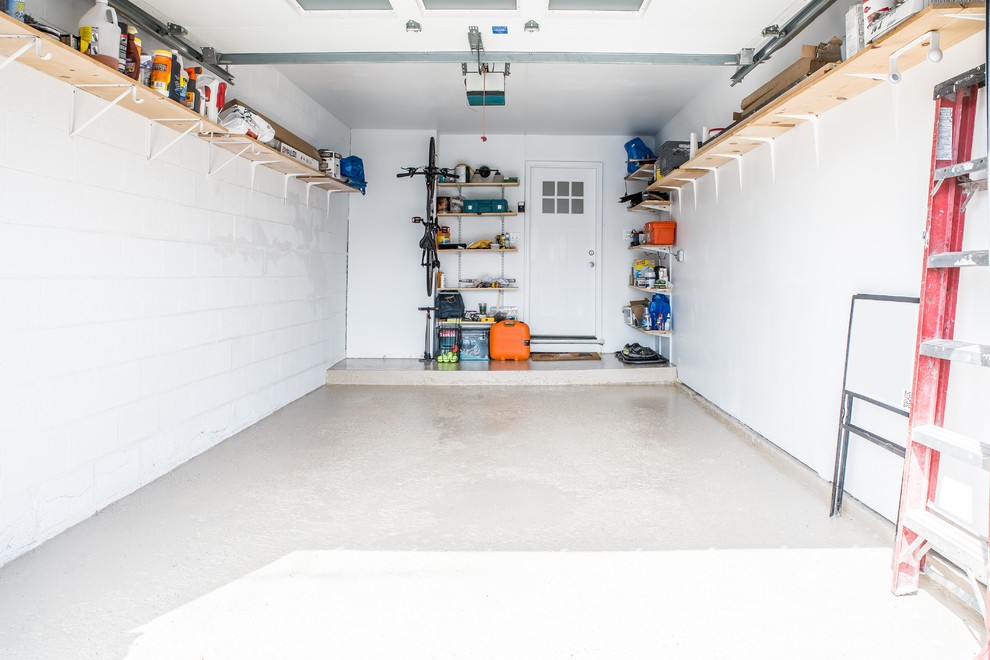 Inspiration for a small contemporary attached one-car garage workshop remodel in Chicago