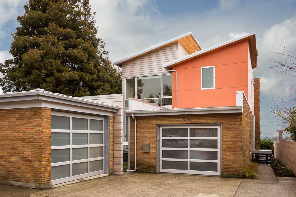 This is an example of a contemporary attached double garage in Seattle.