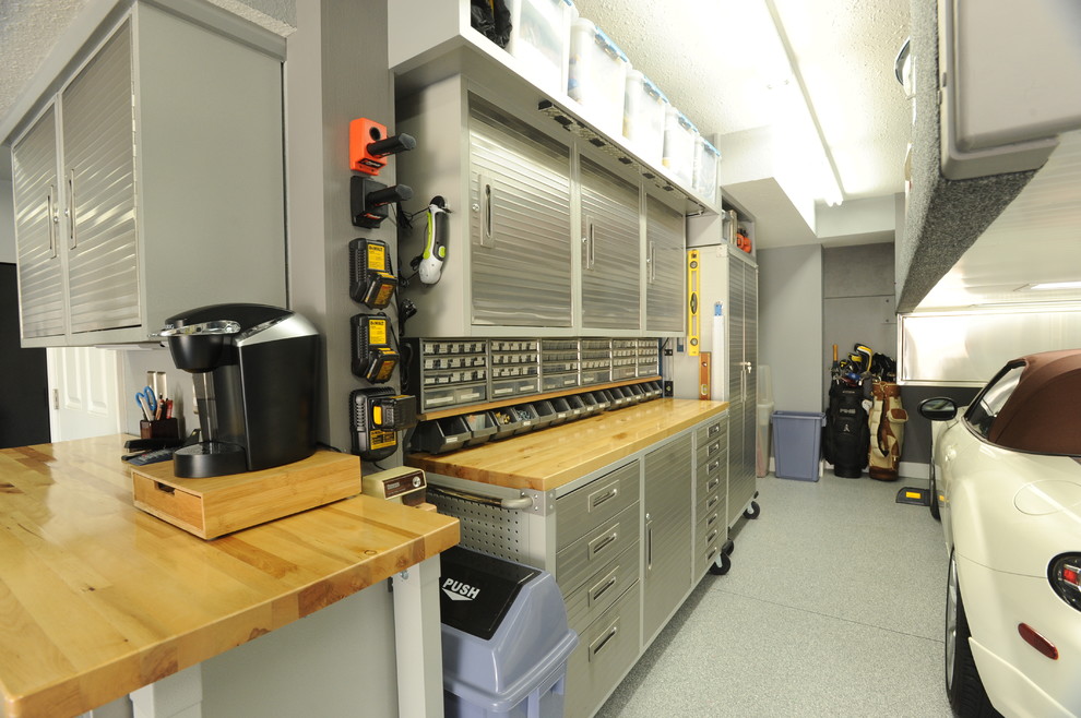 Inspiration for a large modern one-car garage workshop remodel in Other