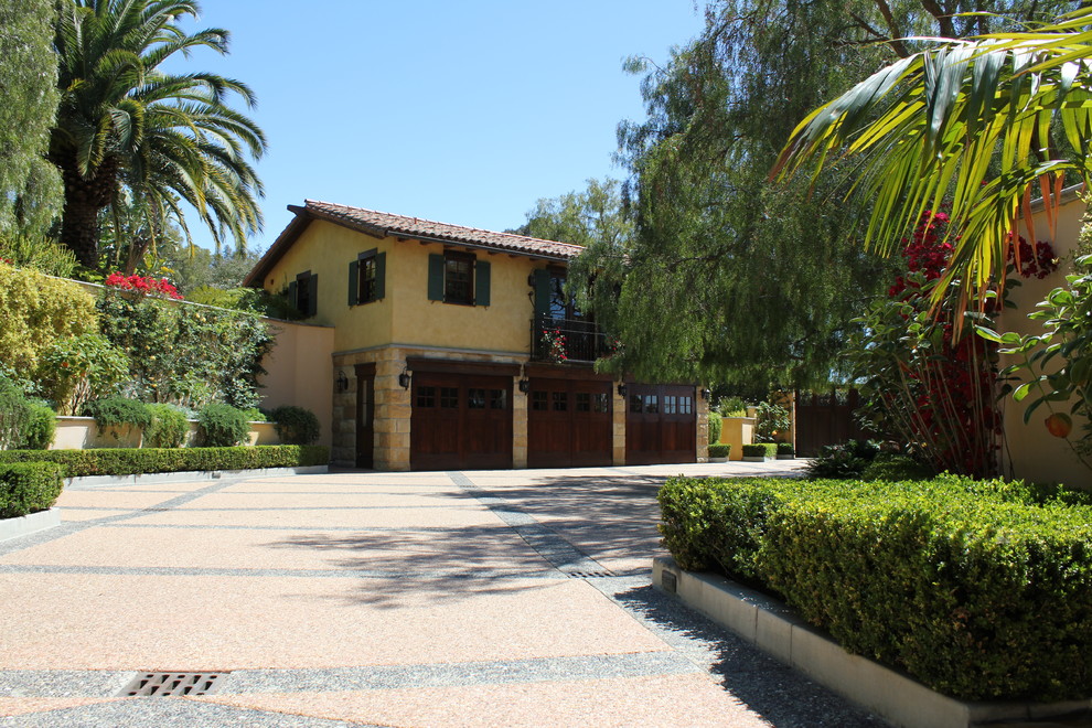 This is an example of a large mediterranean detached garage in Santa Barbara with three or more cars.