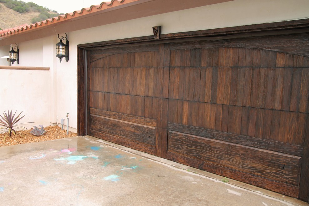 Inspiration for a small mediterranean attached two-car garage remodel in Los Angeles
