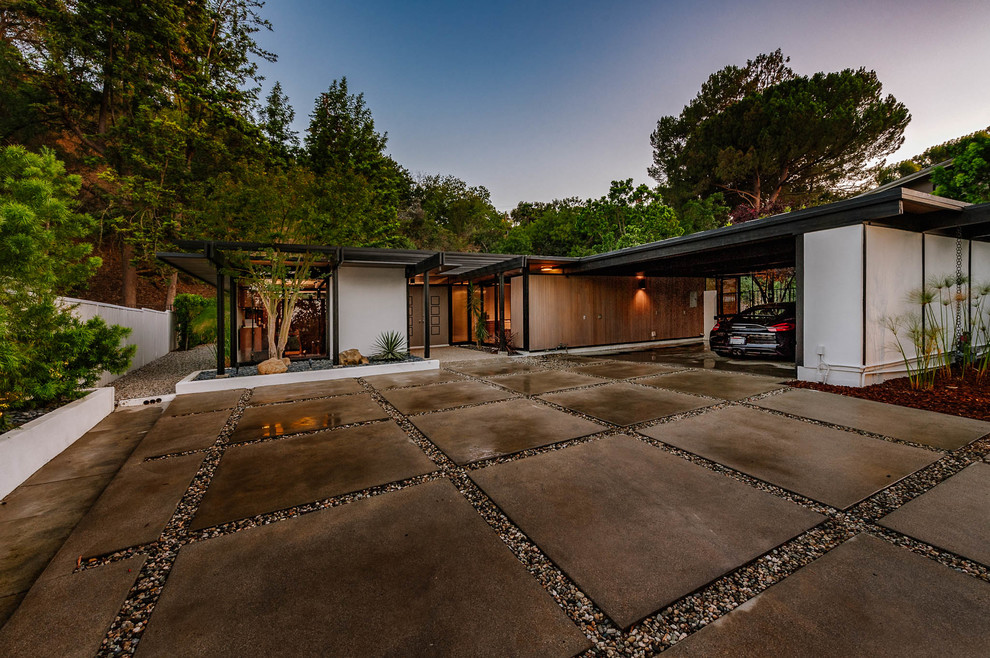 Large mid-century modern attached two-car carport photo in Los Angeles