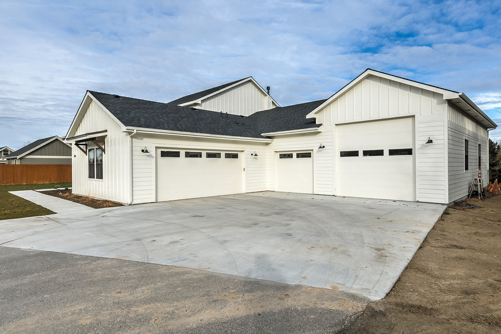 Design ideas for an expansive country attached garage in Boise with four or more cars.