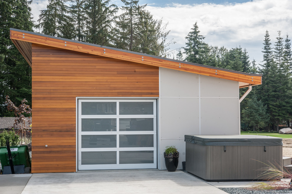 Стильный дизайн: отдельно стоящий гараж среднего размера в стиле модернизм для одной машины - последний тренд