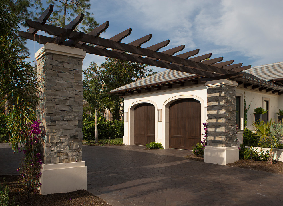 Garage - large transitional attached two-car garage idea in Miami