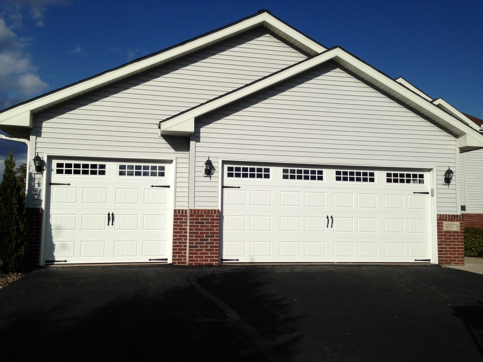 Photo of a medium sized classic attached garage in Minneapolis with three or more cars.