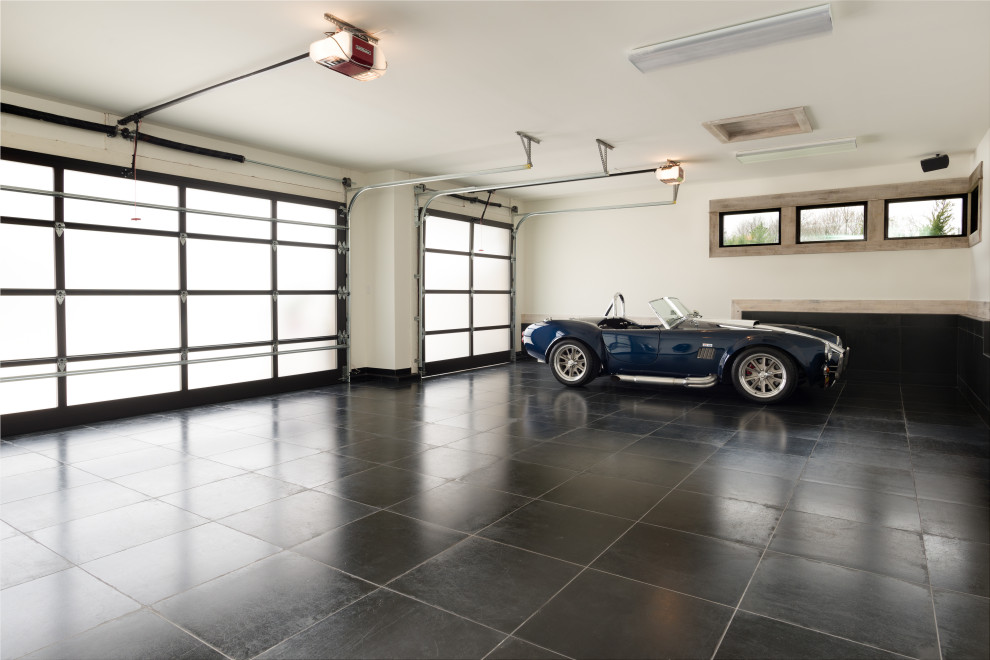 Inspiration for a large modern attached garage in Kansas City with three or more cars.