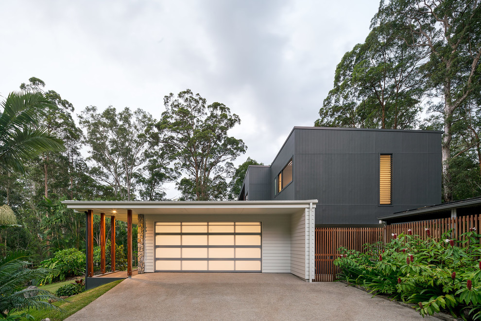 This is an example of a medium sized contemporary attached double garage in Sunshine Coast.