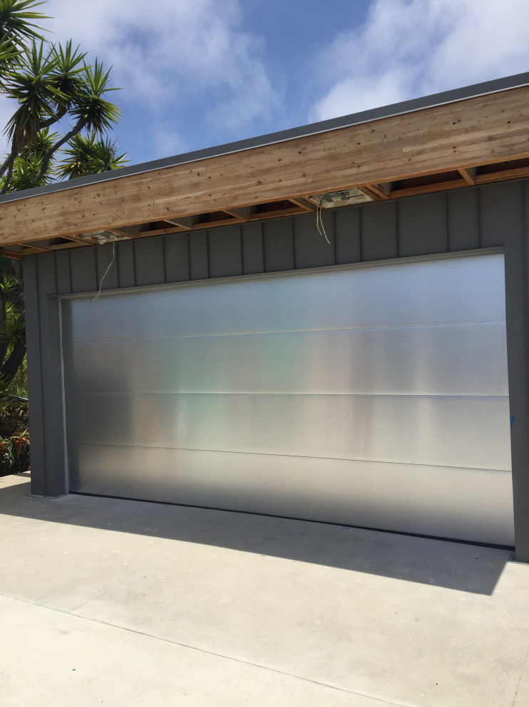 This is an example of a medium sized modern attached double garage workshop in Orange County.