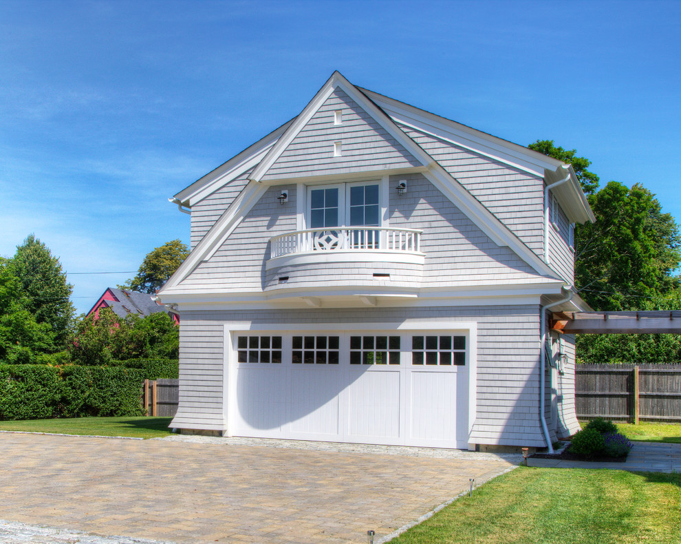 Example of a large classic detached three-car garage design in Other