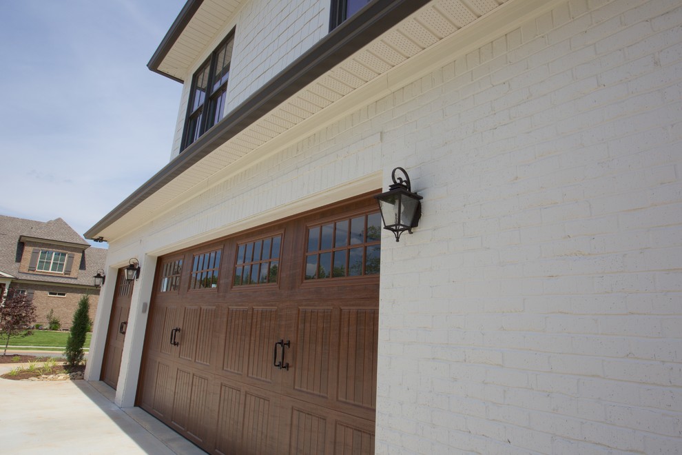 This is an example of a traditional attached garage in Other with three or more cars.