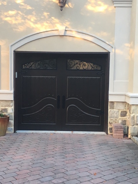 Example of a small tuscan attached one-car garage design in New York