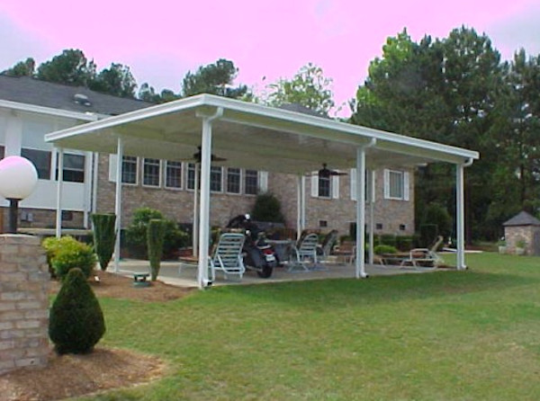 Example of an arts and crafts one-car carport design in Other