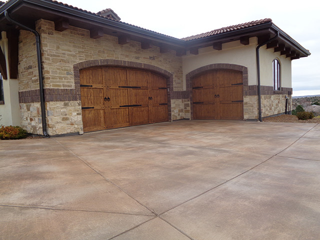 Garage - large mediterranean attached three-car garage idea in Denver