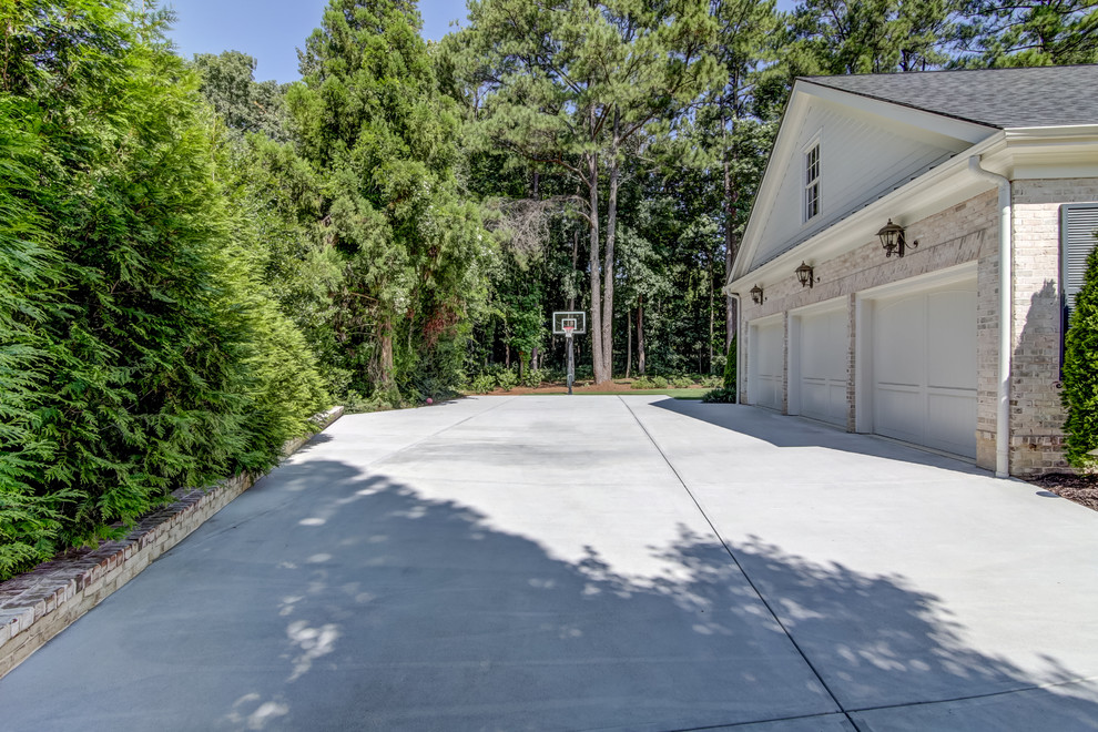 Photo of a large traditional attached garage in Atlanta with three or more cars.